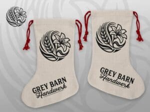 Handmade poly-linen Christmas stocking with Grey Barn Handwerk logo and red rope hanger
