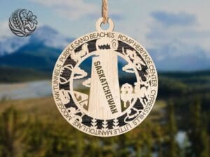 Saskatchewan wooden ornament with laser-cut prairie landmarks hanging against blue sky