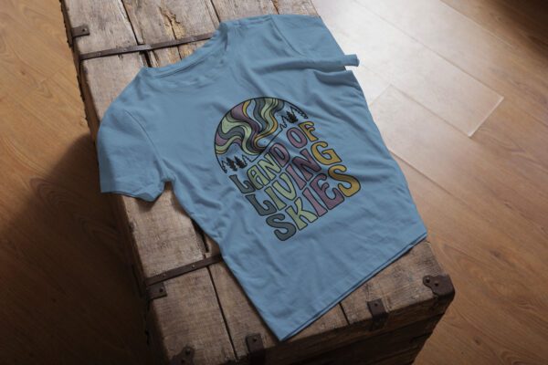 Land of Living Skies T-Shirt design showcasing Saskatchewan's famous nickname on premium organic cotton