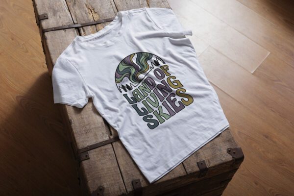 Land of Living Skies T-Shirt design showcasing Saskatchewan's famous nickname on premium organic cotton