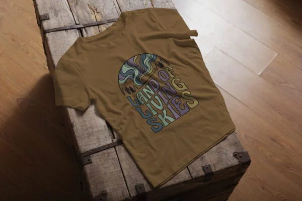 Land of Living Skies T-Shirt design showcasing Saskatchewan's famous nickname on premium organic cotton