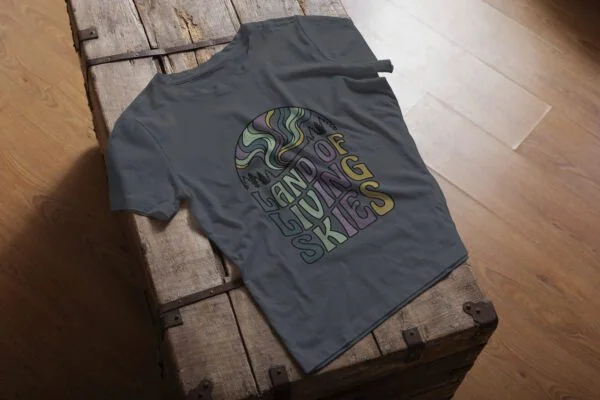 Land of Living Skies T-Shirt design showcasing Saskatchewan's famous nickname on premium organic cotton