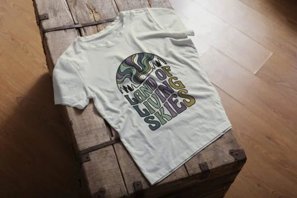 Land of Living Skies T-Shirt design showcasing Saskatchewan's famous nickname on premium organic cotton