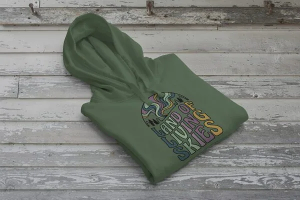 Land of Living Skies Bunnyhug displayed on rustic Saskatchewan barn wood background