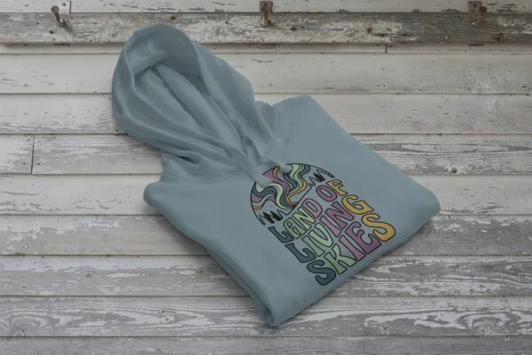 Land of Living Skies Bunnyhug displayed on rustic Saskatchewan barn wood background