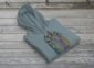 Land of Living Skies Bunnyhug displayed on rustic Saskatchewan barn wood background