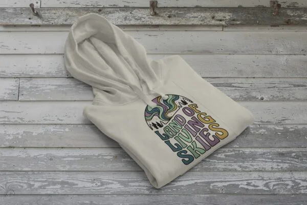 Land of Living Skies Bunnyhug displayed on rustic Saskatchewan barn wood background