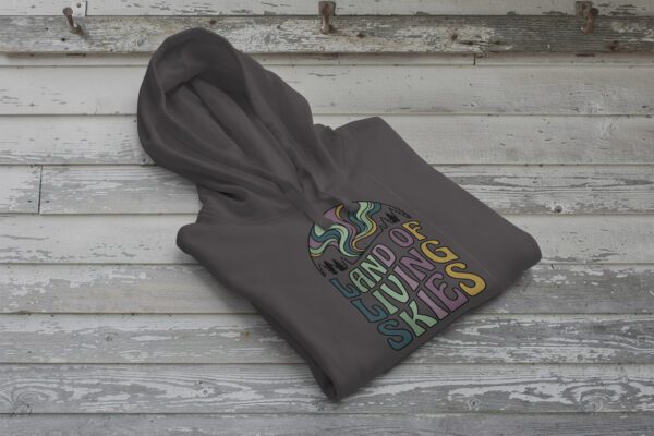 Land of Living Skies Bunnyhug displayed on rustic Saskatchewan barn wood background