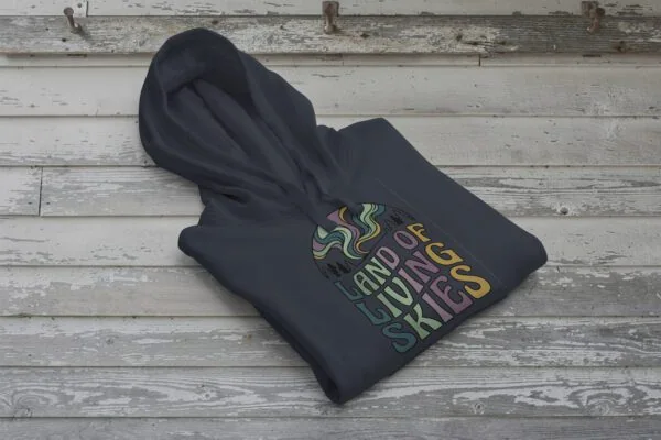 Land of Living Skies Bunnyhug displayed on rustic Saskatchewan barn wood background