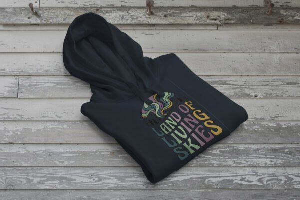 Land of Living Skies Bunnyhug displayed on rustic Saskatchewan barn wood background