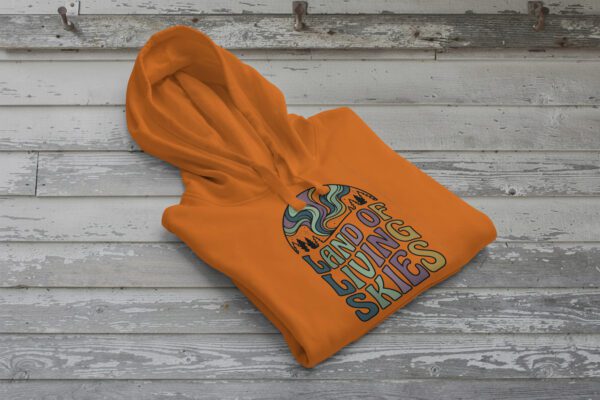 Land of Living Skies Bunnyhug displayed on rustic Saskatchewan barn wood background