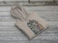 Land of Living Skies Bunnyhug displayed on rustic Saskatchewan barn wood background