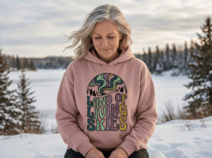 Land of Living Skies Bunnyhug displayed on a 50s woman winter camping