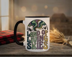 Land Of Living Skies Mug in black interior showing Saskatchewan prairie sky design on white ceramic coffee cup