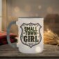 Small Town Girl Mug in grey interior showing Saskatchewan design on white ceramic coffee mug