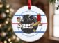 Round team ornament on a Christmas tree, hockey puck team logo on an ice rink design