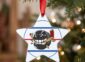 Star team ornament on a Christmas tree, hockey puck team logo on an ice rink design