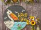 Pelican and Dragon Flies Lake Life Sign on the wall